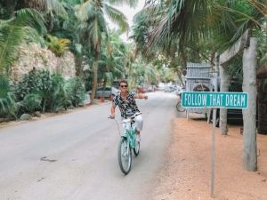 Young man on bike in exotic place Young man on bike in exotic place